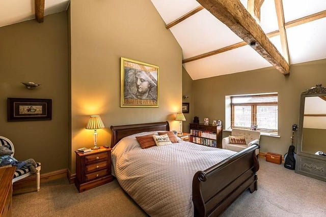 A double bedroom with vaults and beams.