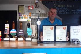 Three B’s Micropub owner Mark Bates with his latest certificates.