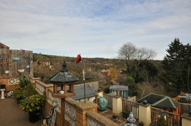 A viewpoint from the tiered garden of the semi-detached dormer bungalow.