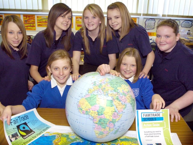 Pupils from George Pindar Community Sports College visit Seamer and Irton School to promote Fairtrade. Front (from left) Seamer pupils Amelia Carver and Mollie Bird with Pindar students (back from left) Mollie Holder, Jade Hutchinson, Emma Cairney, Zoe Atkinson and Rachel Harker. 081032