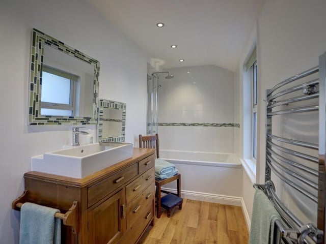 One of two bathrooms within the house to feature both bath and shower.
