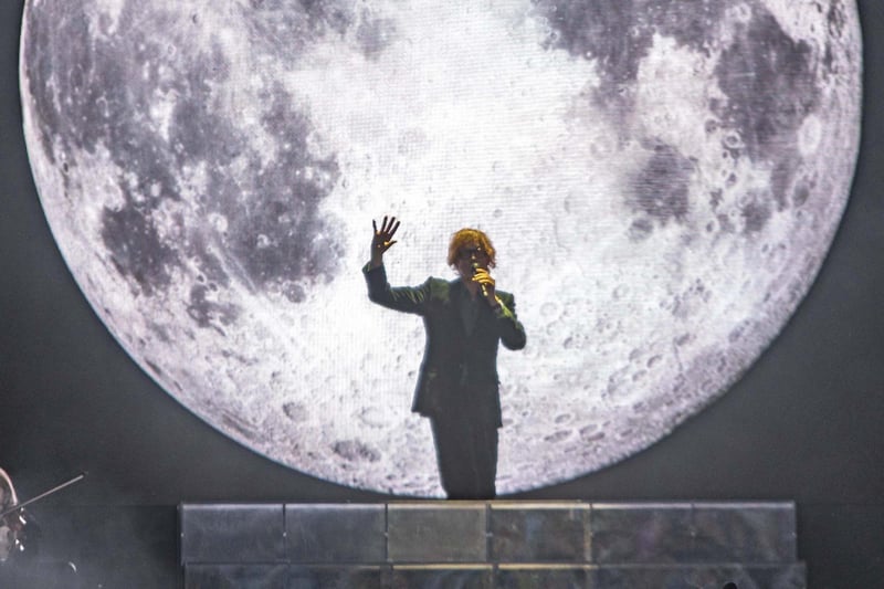 A huge full moon backdrop welcomes Pulp to the stage.