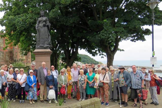 Members with the statue of Queen Victoria
