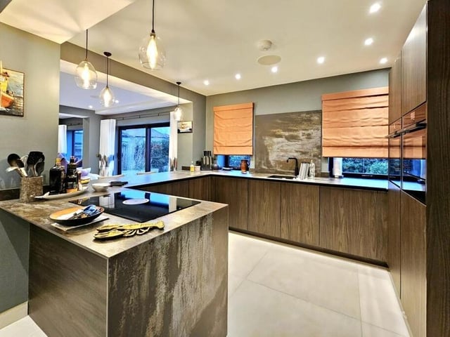 The modern, well equipped kitchen flows through to dining and living areas.