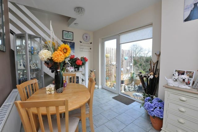 Dining space with a patio door to the garden and staircase upstairs.