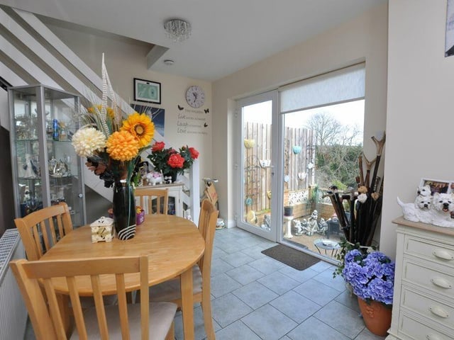Dining space with a patio door to the garden and staircase upstairs.
