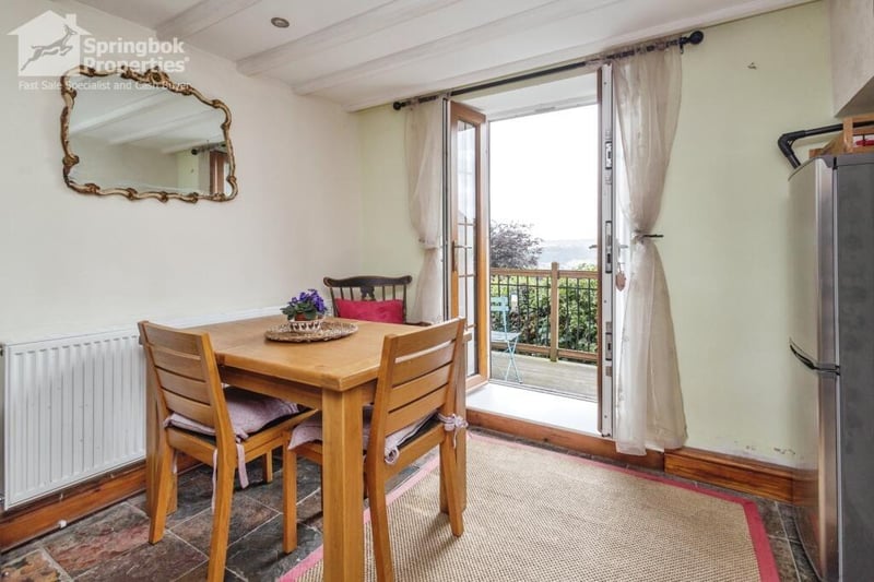 The dining area opens out to a decked balcony.