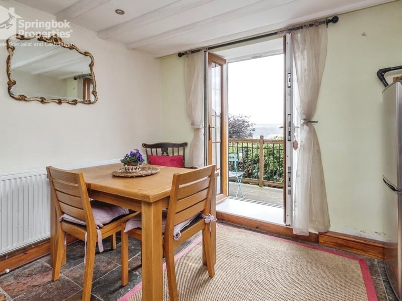The dining area opens out to a decked balcony.