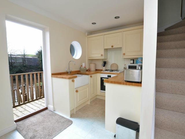 The kitchen and diner opens directly to the private decking by the river.