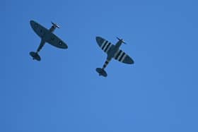 Spitfire planes fly overhead. (Pic credit: Glyn Kirk / Getty Images)