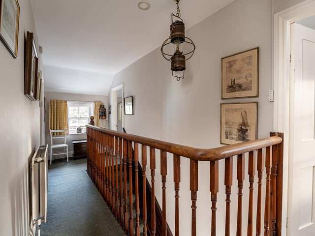 The first floor landing with wooden balustrade.