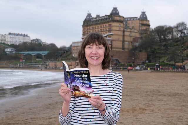 Author Glenda Young with the first book in her series on South Bay beach