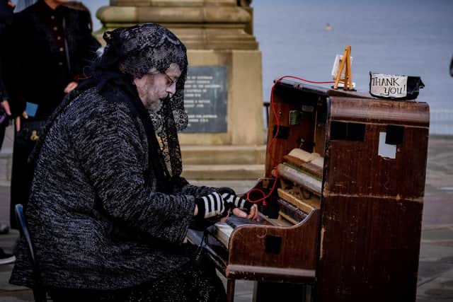 A pianist entertains the crowds on Whitby West Cliff.