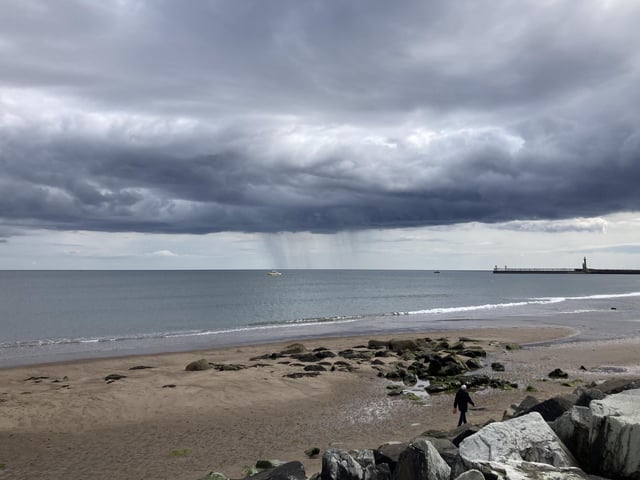 Rain clouds over Whitby beach, by Paulina Templeton.