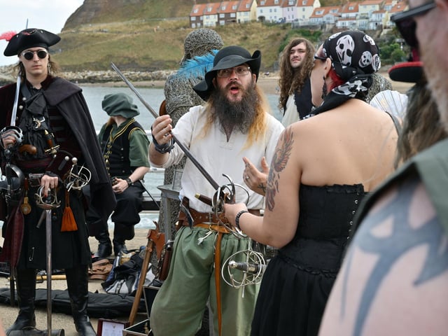 Festival-goers at the Bandstand talking about pirate weapons. photo: Richard Ponter