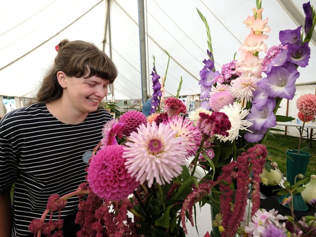 Danby Show Steward Holly Smith viewing the flowers.