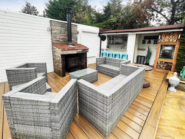 This decked seating area is perfect for spending time with friends and family, with a garden bar to the rear.