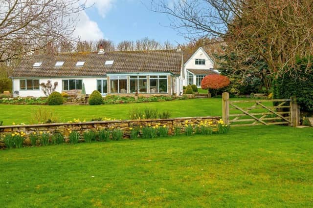 A view of the attractive property across its landscaped garden.