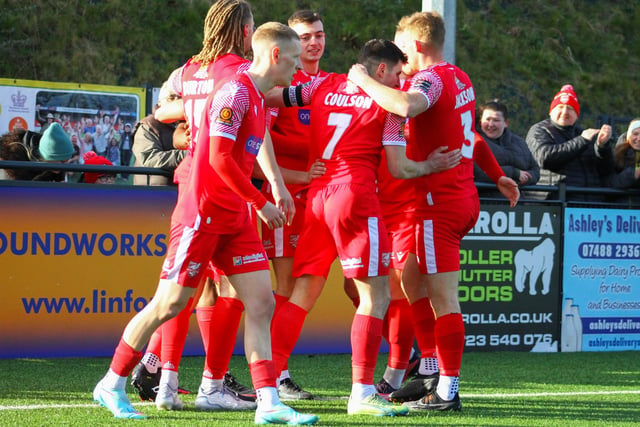 The Scarborough Athletic captain is congratulated by his teammates after making it 3-1 at home to Leamington.