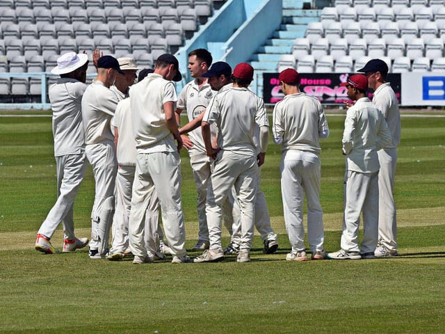 Scarborough CC 2nds surround skipper Charlie Hopper as he claims an early wicket