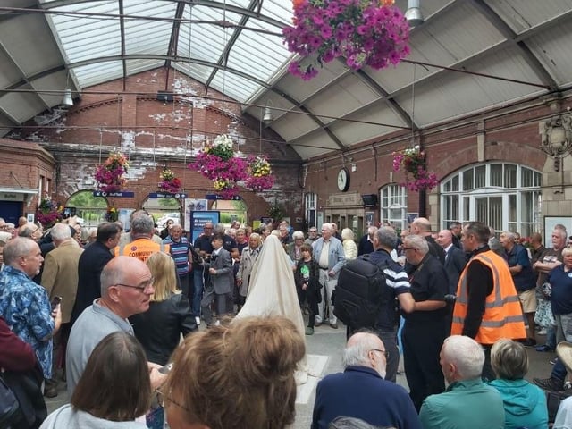 Guests waiting for the grand unveiling, making the station buzz with anticipation.