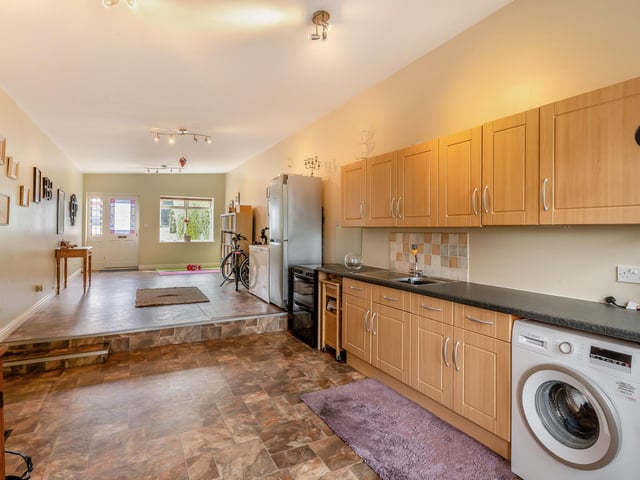 The large, split level utility room with gym or boot room.