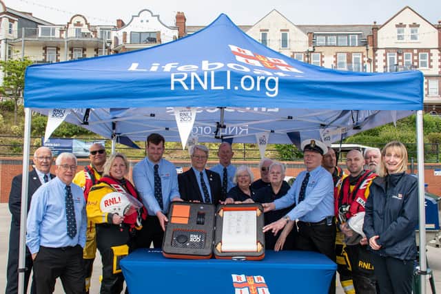 Bridlington RNLI volunteers with the RNLI ‘Connecting our Communities’ scroll. - RNLI/Mike Milner