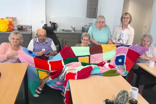 L-R is Margaret Scythe, Alan Hiscox, Yvonne Lowe, Viv Butcher, Jean Pindar and Barbara Hill, with the blanket they made.