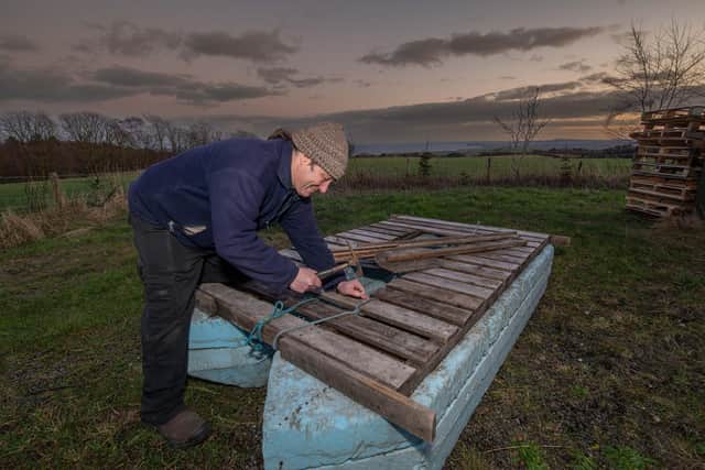 Competitor Edmund Ulliott putting the final touches to his raft and loading it onto his trailer.