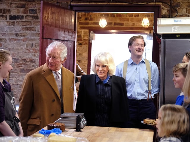 King Charles and Camilla, the Queen Consort talk to staff.