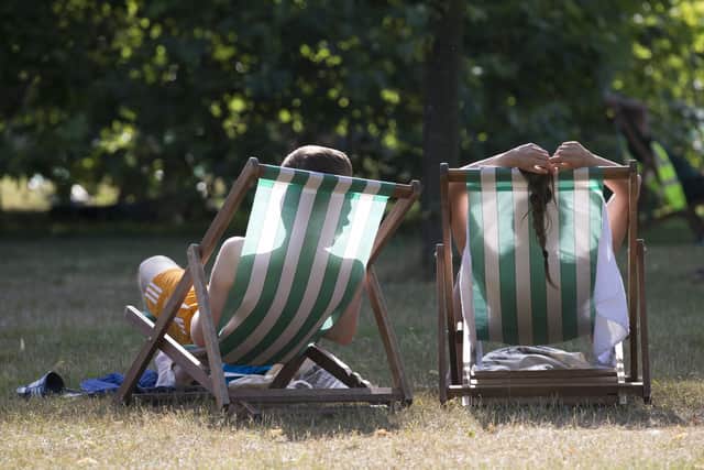 People enjoy warm weather in the park.