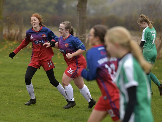 Ellie-Mae Bloomfield, left, number 16, celebrates scoring Scarborough Ladies Under-15s' second goal in the 2-1 home win against Wigginton Grasshoppers, with teammate Sarah Dicks