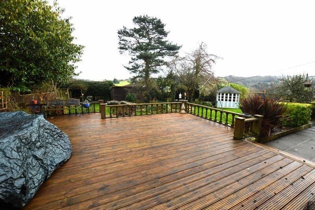 A large decked seating area in the garden overlooks the valley.