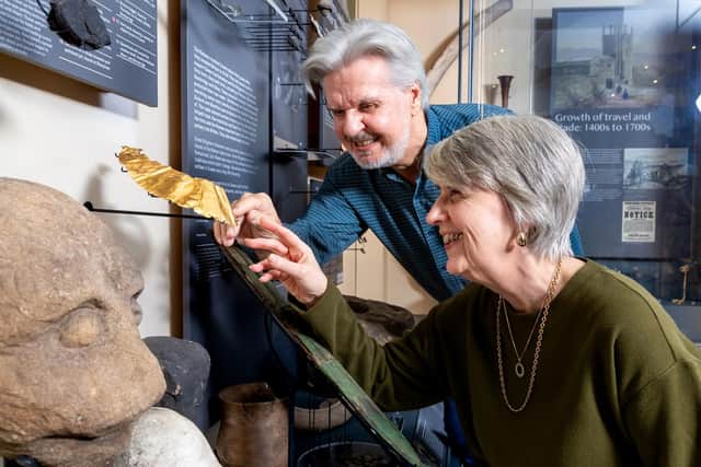 Craven Museum volunteers, Graham Bonner and Sarah Hughes-Gabri, examine the gold lunula which has gone on permanent display after being found locally by a metal detectorist.