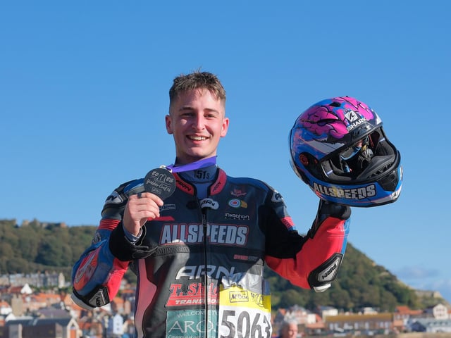 A Scarborough 10k finisher who completed the event in full motorcycling kit proudly displaying their medal.. Photo by Richard Ponter