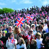 A flag waving crowd of more than 6,000 greet the Queen's arrival at the Open Air Theatre with a deafening cheer!
102087a