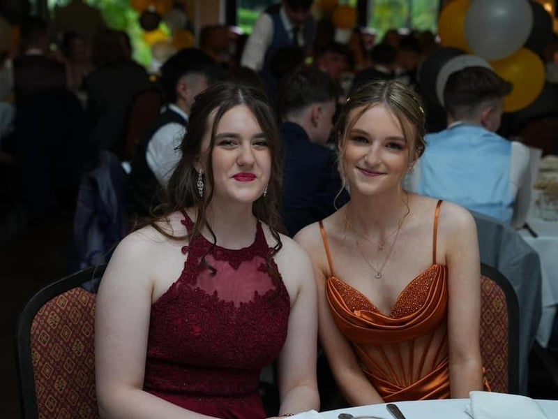 Two beautiful students enjoying the event together.