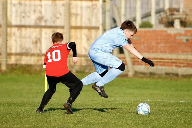 A Titans player takes evasive action. PHOTO BY TCF PHOTOGRAPHY