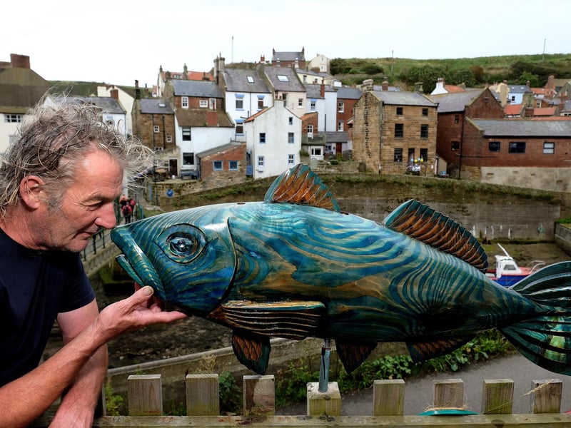 Sculptor Steve Iredale with one of his sculptures and the backdrop of Staithes.
picture: Richard Ponter