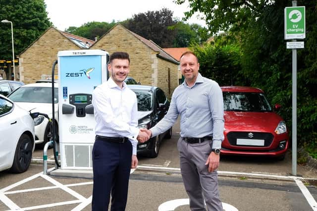 North Yorkshire Council’s executive member for highways and transport, Cllr Keane Duncan (left), with the chief executive officer of Zest, Robin Heap, in front of a new rapid electric vehicle charger in Cleveland Way car park in Helmsley.