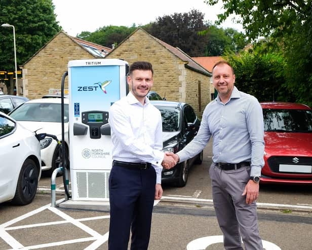 North Yorkshire Council’s executive member for highways and transport, Cllr Keane Duncan (left), with the chief executive officer of Zest, Robin Heap, in front of a new rapid electric vehicle charger in Cleveland Way car park in Helmsley.