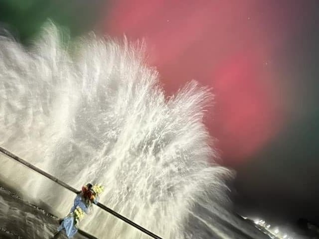 Incredible shot of waves crashing as Northern Lights glimmer above Scarborough North Bay.