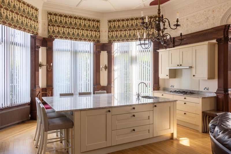The kitchen has a granite-topped central island with breakfast bar.