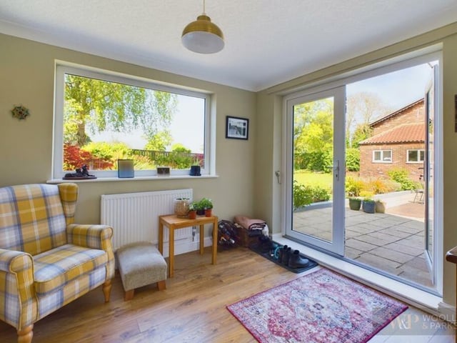 A garden room with doors leading outside.