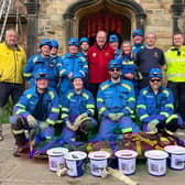 Whitby Coastguard team at St Mary's Church, Whitby, on completion of the challenge, with Rev Michael Gobbett.
