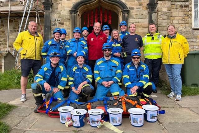 Whitby Coastguard team at St Mary's Church, Whitby, on completion of the challenge, with Rev Michael Gobbett.