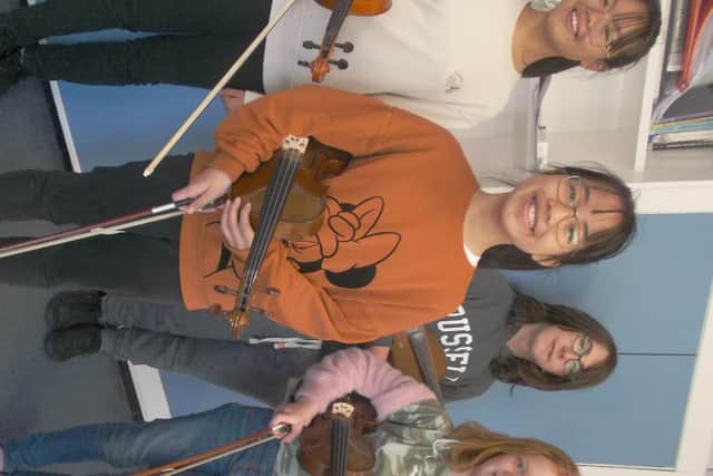 Youngsters from Whitby Music Centre with string instruments.