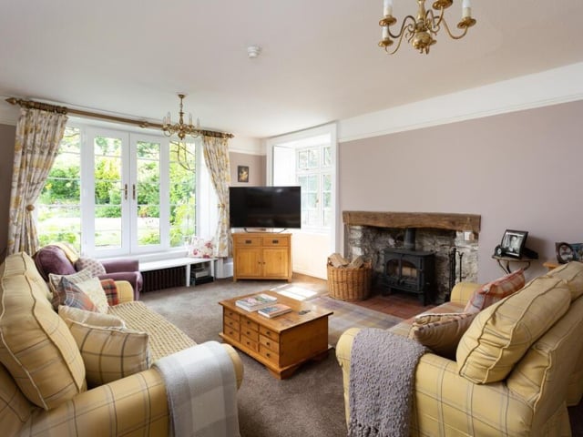 The sitting room has original shutters, and French doors to the garden.