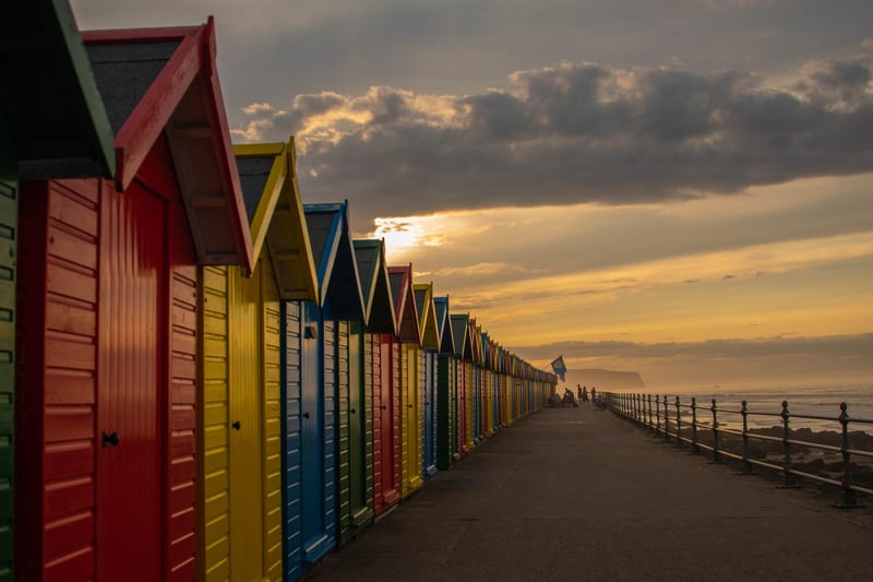 Colourful beach huts on Whitby seafront, by Deborah McCarthy.