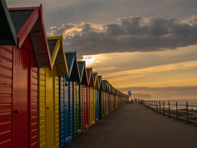Colourful beach huts on Whitby seafront, by Deborah McCarthy.